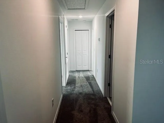 a view of a hallway with a wooden door