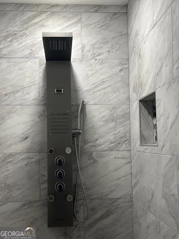 a bathroom with a shower and a sink