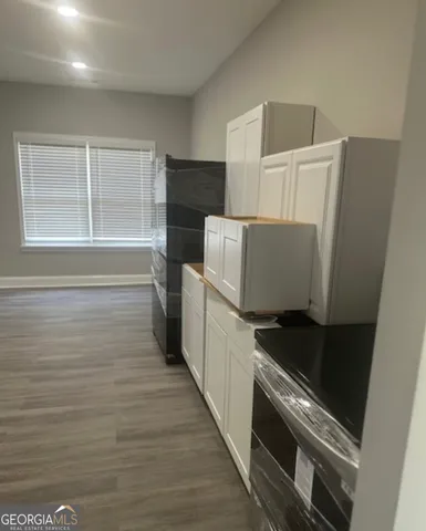 a kitchen with a refrigerator and a stove