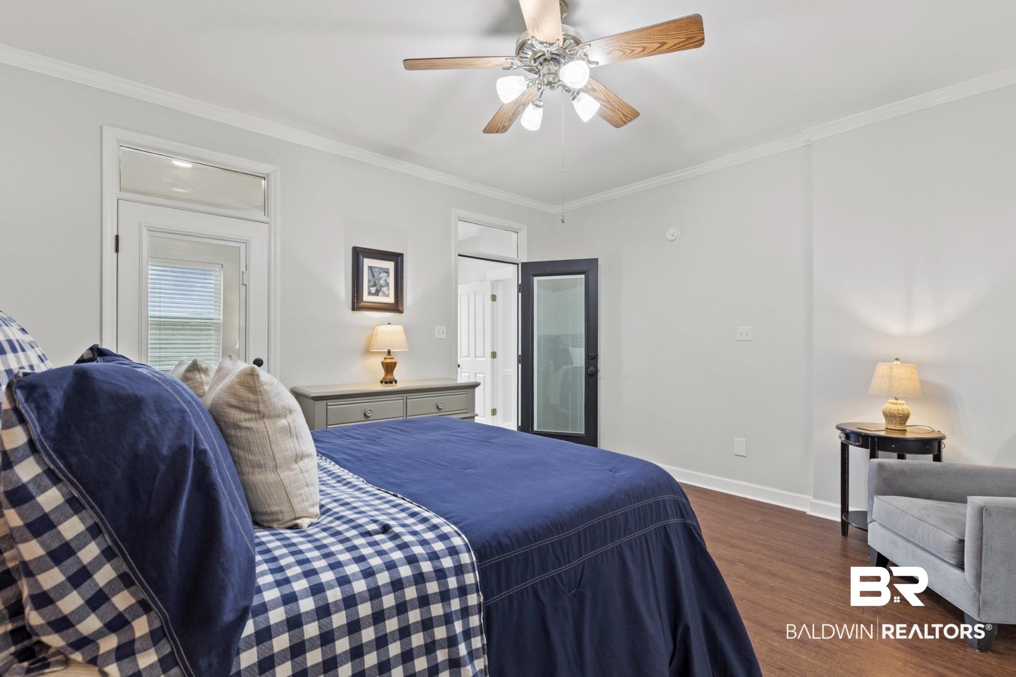 12171 Marguerite Drive Coden, AL 36523 - Photo 14 of 44 Interior room featuring wood-finish flooring, white walls, and crown molding