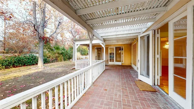 a view of a porch with wooden floor and stairs