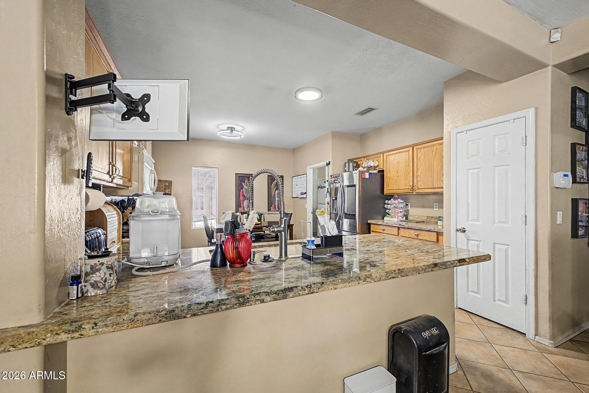 5301 West Grenadine Road Laveen, AZ 85339 - Photo 11 of 37 a kitchen with stainless steel appliances granite countertop a sink a stove and a wooden cabinets