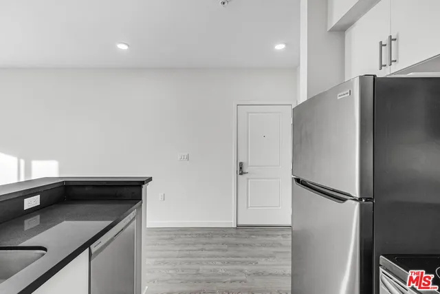 a kitchen with a refrigerator and a sink