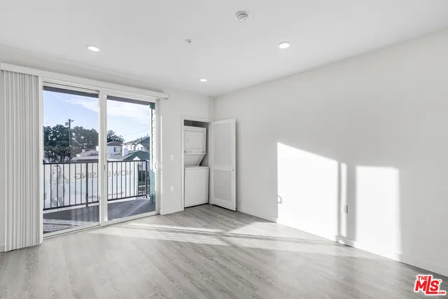 a view of a livingroom with wooden floor and a window