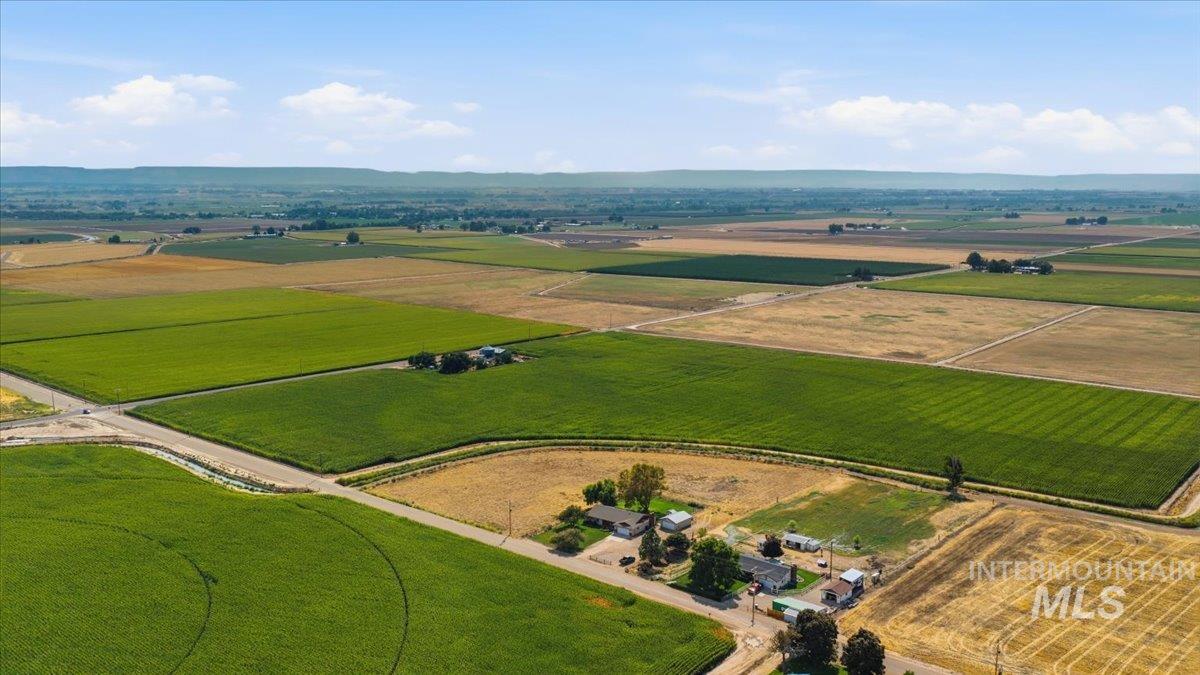 26201 Hop Road Caldwell, ID 83607 - Photo 38 of 45 Expansive agricultural land featuring cultivated fields, distinct property boundaries, and distant rolling terrain