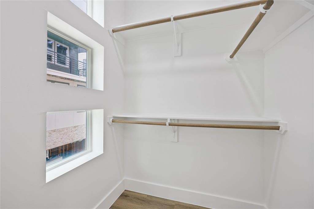 1805 Emir Street, Unit L Houston, TX 77009 - Photo 21 of 35 The bedroom includes a large walk-in closet with windows to bring in natural light.