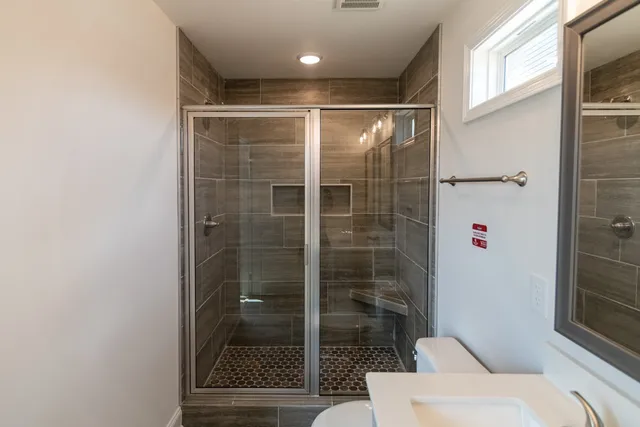 a bathroom with a shower and a toilet