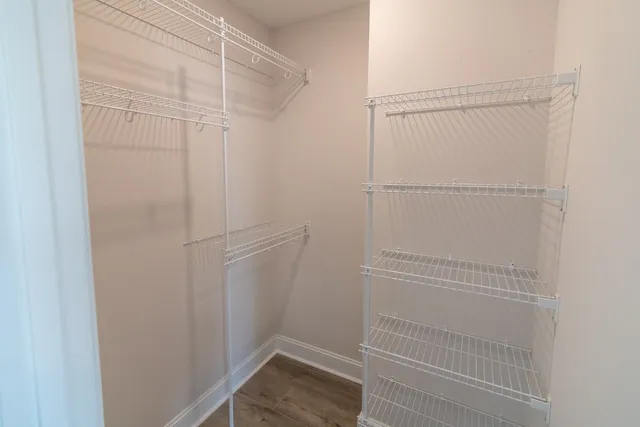 a view of walk in closet with empty racks