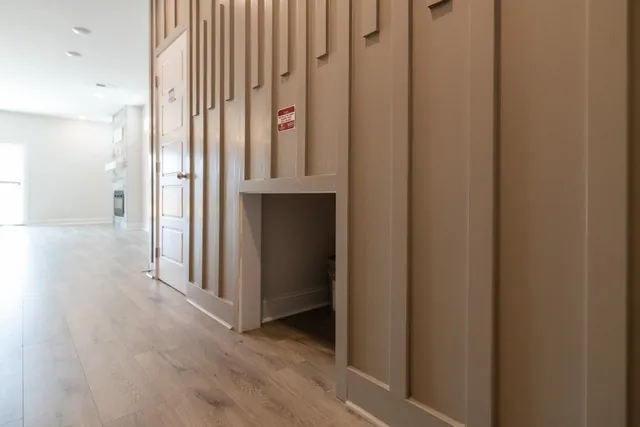 a view of a hallway with wooden floor