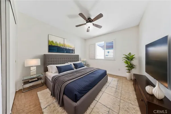 a bedroom with a large bed and a chandelier
