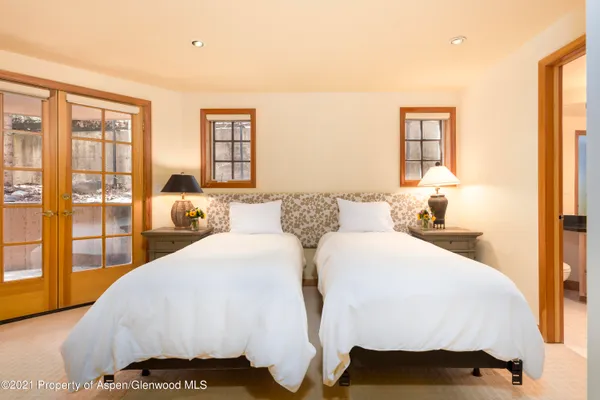 a room with lots of frames and paintings on the wall