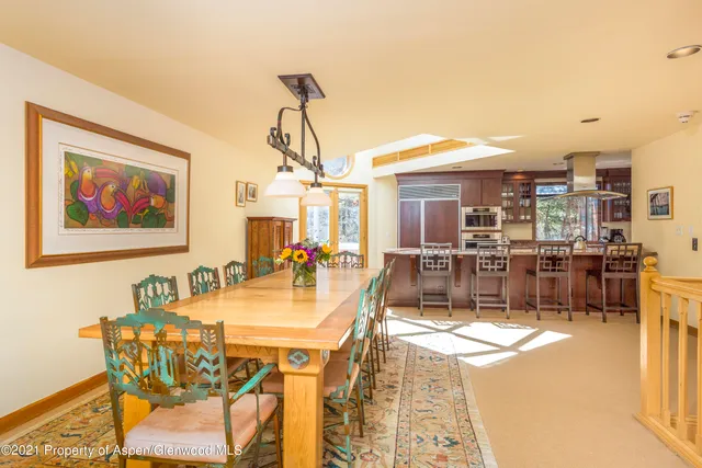 a view of a dining room with furniture and a chandelier