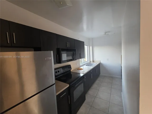 a kitchen with stainless steel appliances a refrigerator and a sink