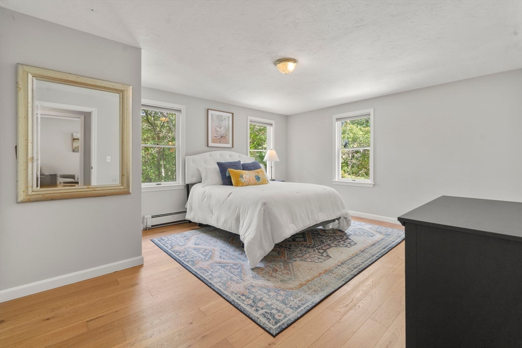 5 Cardinal Road Sandwich, MA 02563 - Photo 2 of 41 a bed sitting in a bedroom next to a window