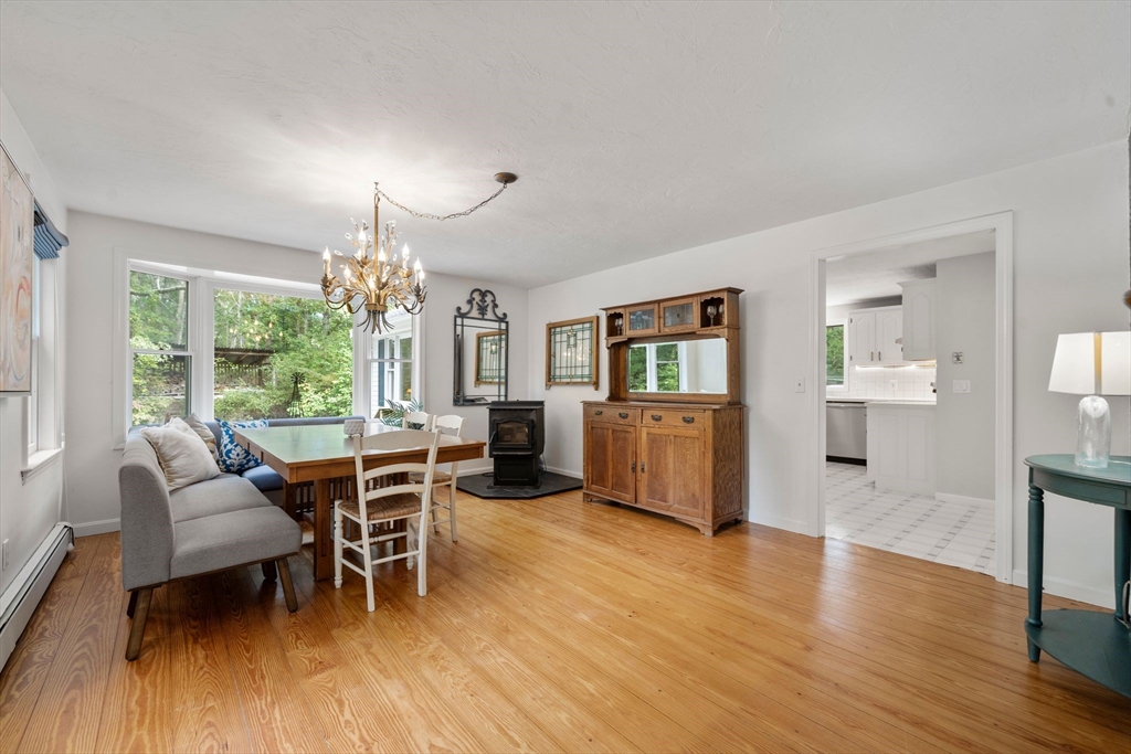 5 Cardinal Road Sandwich, MA 02563 - Photo 23 of 41 a dining room with furniture a chandelier and wooden floor