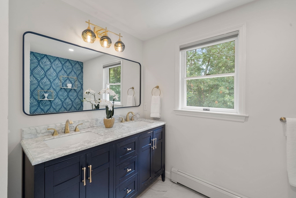 5 Cardinal Road Sandwich, MA 02563 - Photo 5 of 41 a bathroom with a sink vanity and a mirror