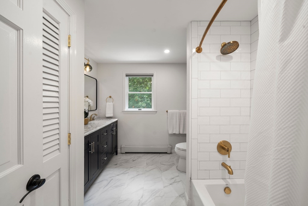 5 Cardinal Road Sandwich, MA 02563 - Photo 7 of 41 a bathroom with a tub sink and mirror