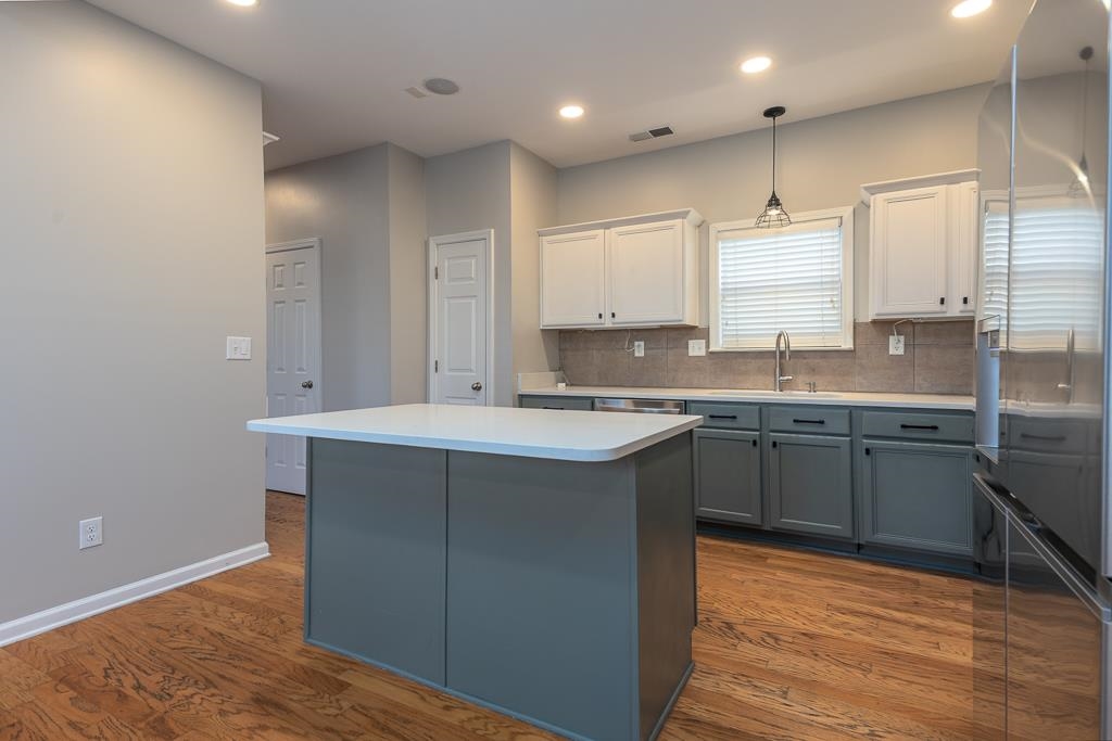 1227 Isle View Drive Memphis, TN 38103 - Photo 16 of 37 a kitchen with stainless steel appliances granite countertop a sink stove and refrigerator