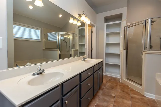 a bathroom with a sink double vanity and a mirror