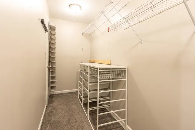 a view of walk in closet with empty racks