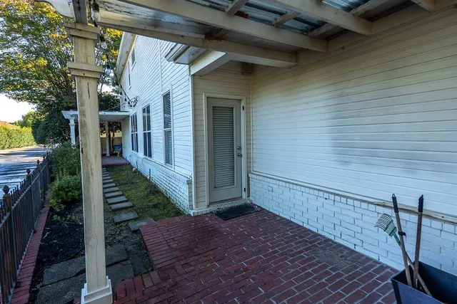 a view of a house with backyard and sitting area