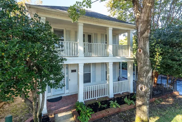 a front view of a house with a garden