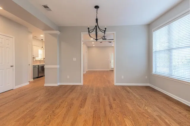 a view of a kitchen with wooden floor and a kitchen