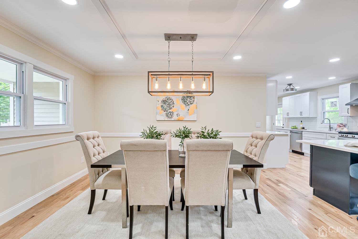2 Devon Road Edison, NJ 08820 - Photo 26 of 69 a view of a dining room with furniture a chandelier and wooden floor