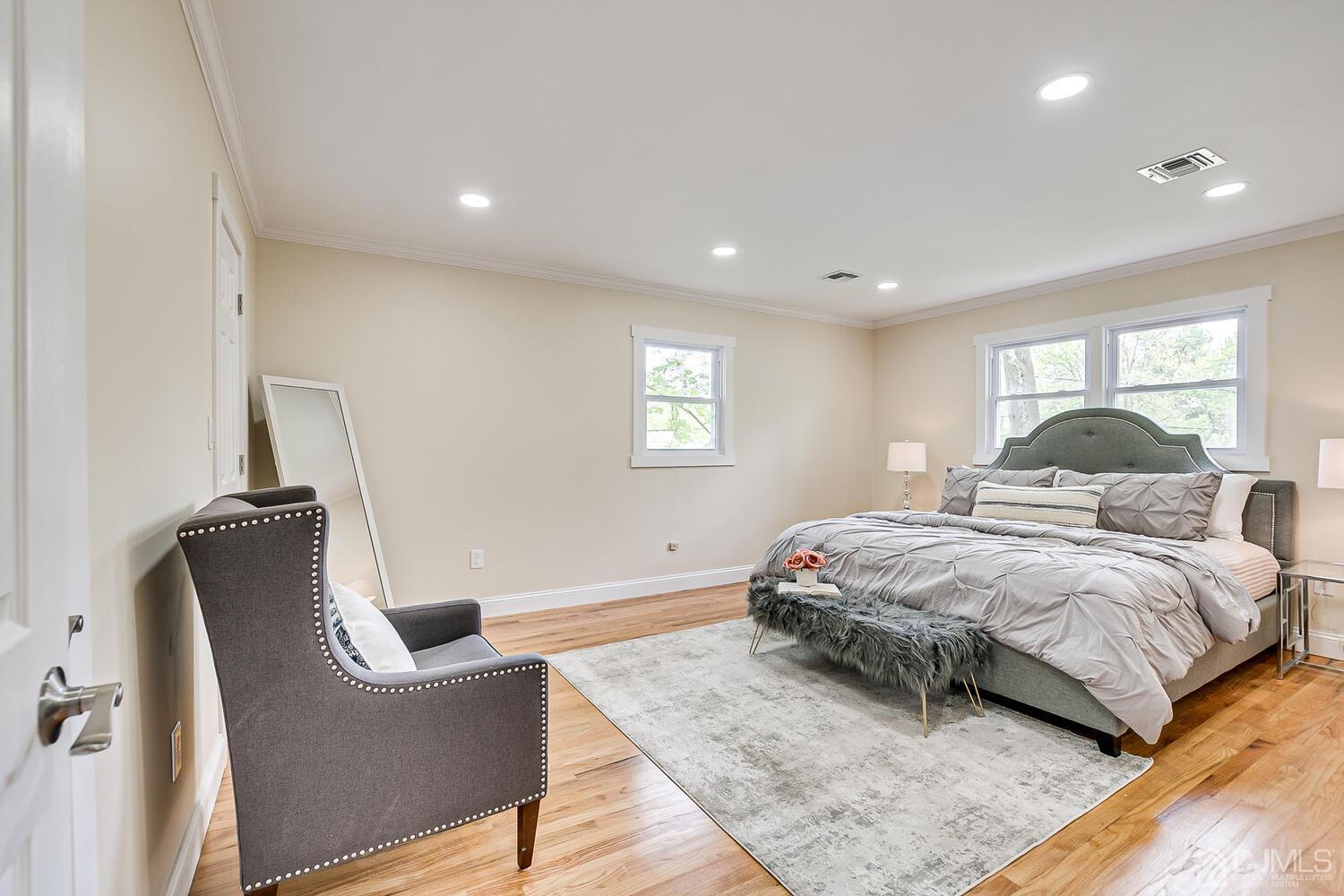 2 Devon Road Edison, NJ 08820 - Photo 44 of 69 a bedroom with a large bed and wooden floor