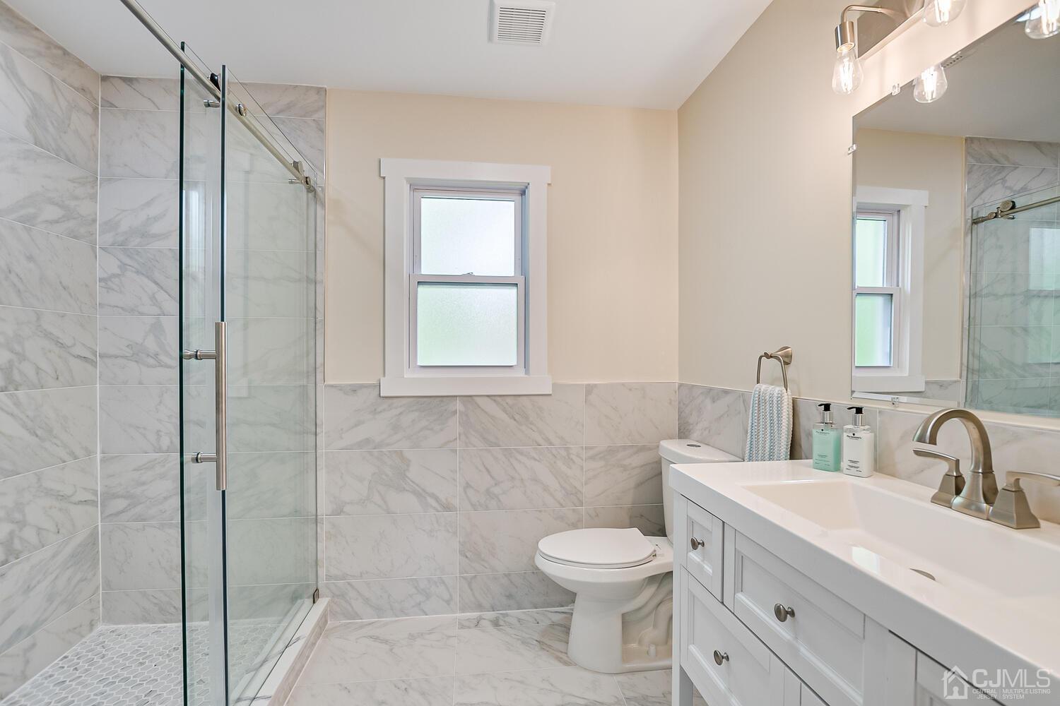 2 Devon Road Edison, NJ 08820 - Photo 46 of 69 a bathroom with a toilet sink and shower