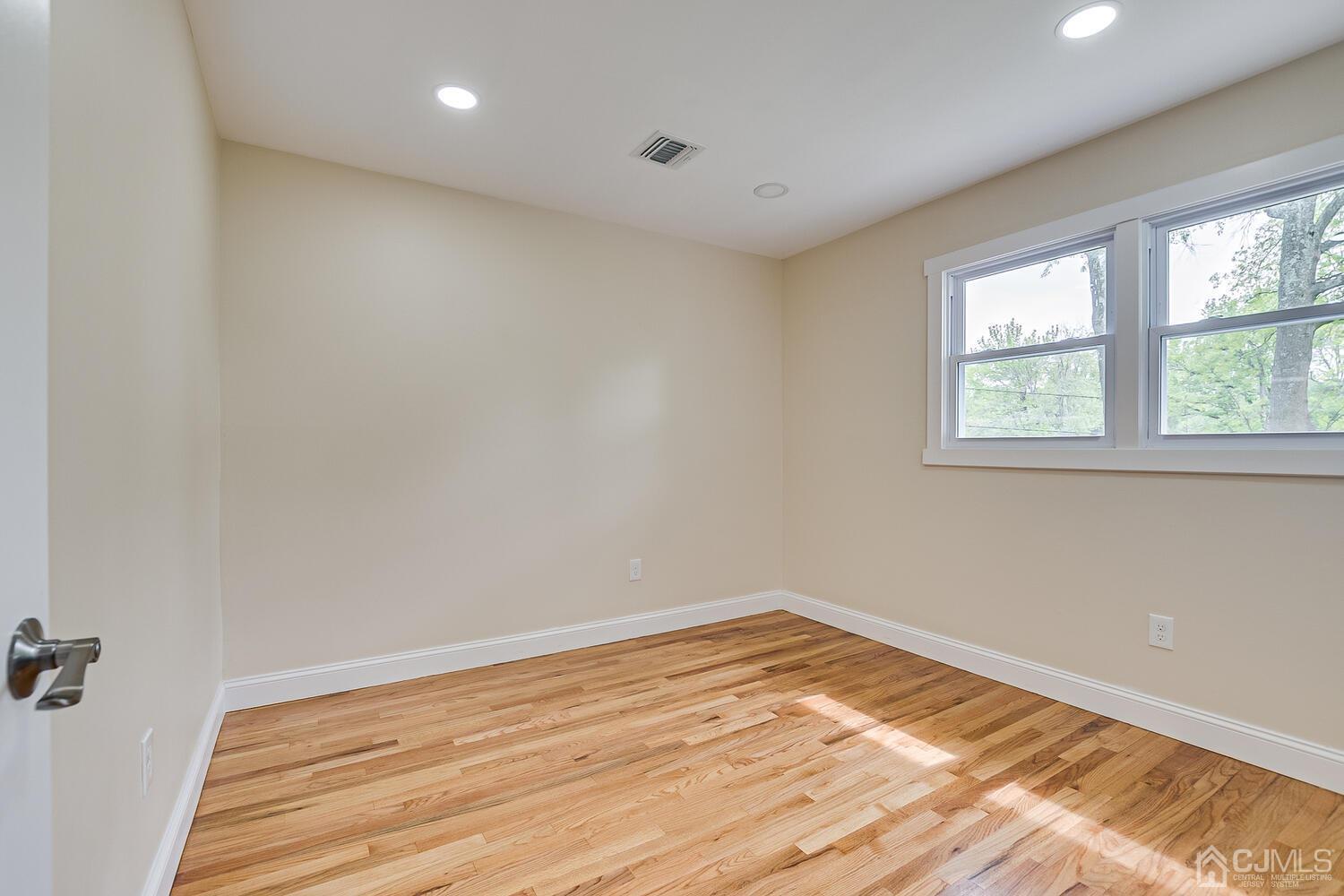 2 Devon Road Edison, NJ 08820 - Photo 50 of 69 wooden floor in an empty room with a window