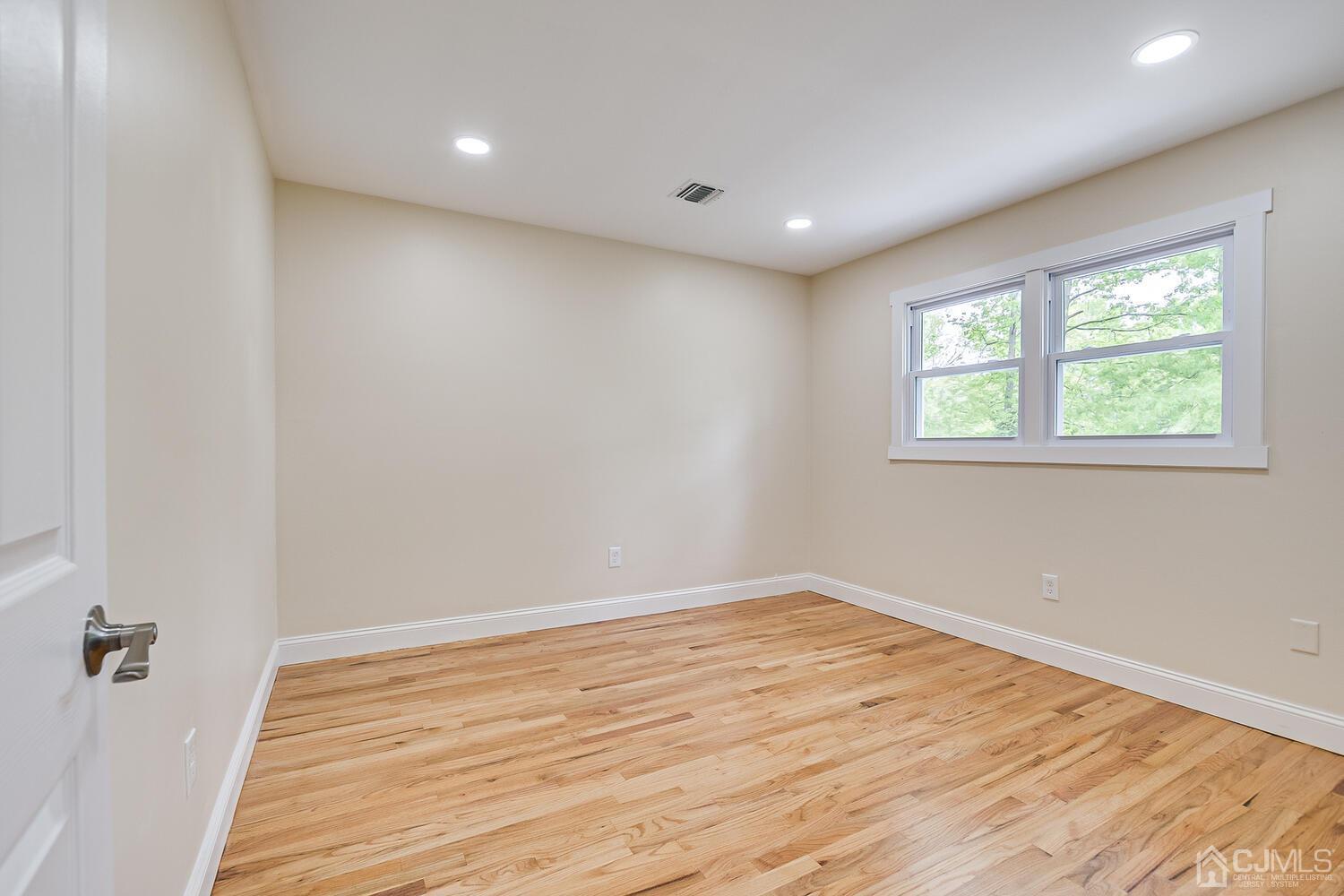 2 Devon Road Edison, NJ 08820 - Photo 54 of 69 a view of empty room with wooden floor and fan