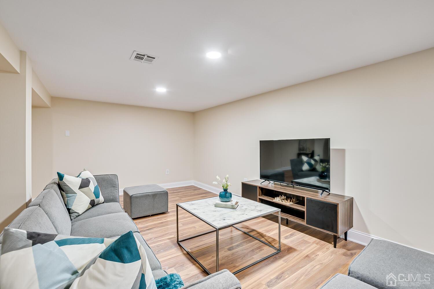 2 Devon Road Edison, NJ 08820 - Photo 62 of 69 a living room with furniture and a flat screen tv
