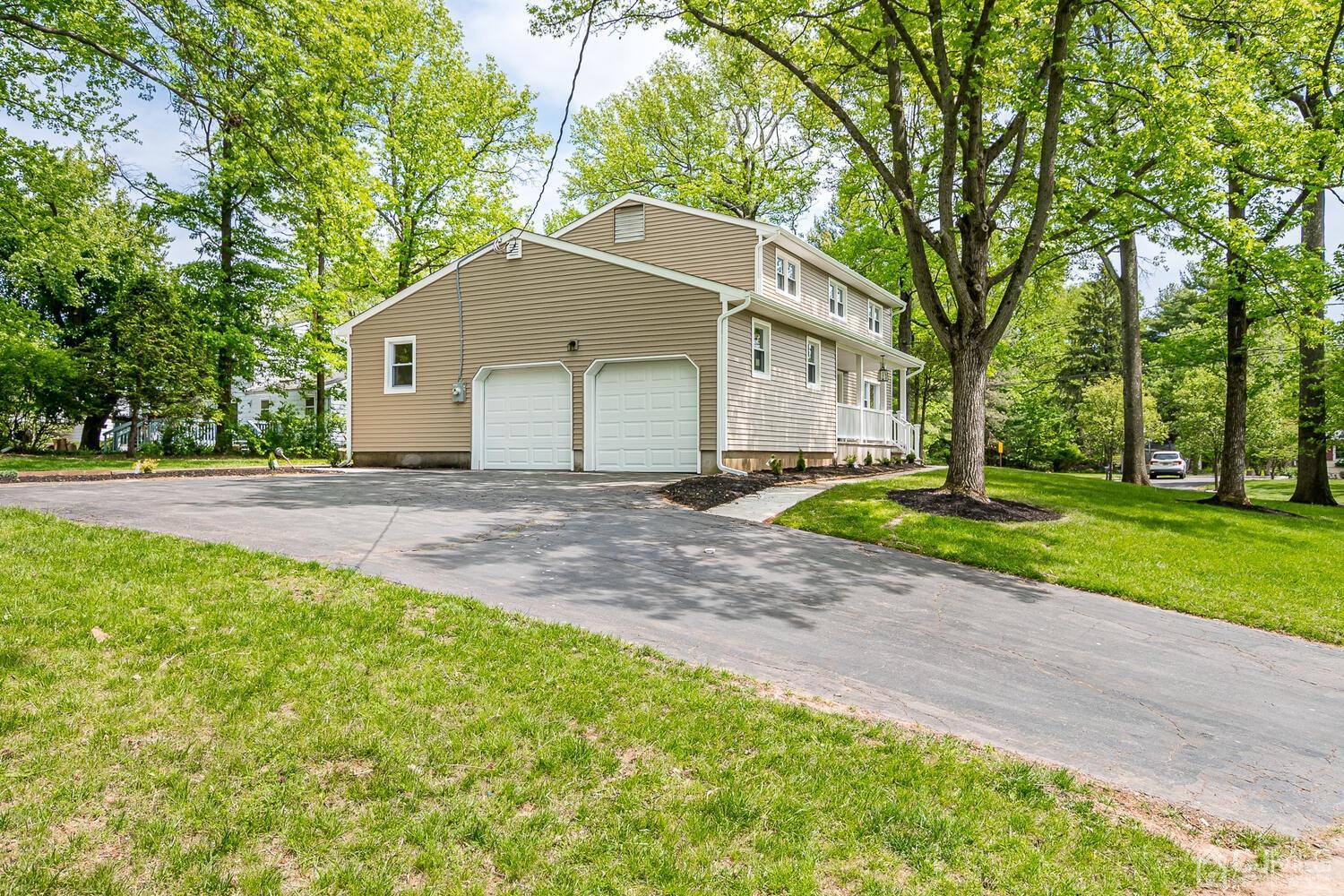 2 Devon Road Edison, NJ 08820 - Photo 8 of 69 a front view of a house with a yard and garage