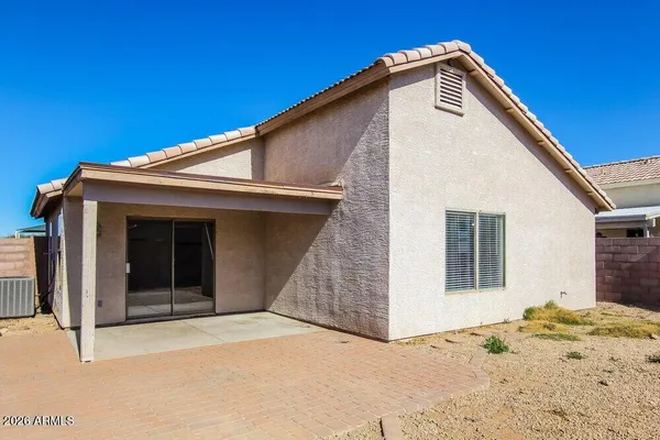 a view of a house with a wooden fence