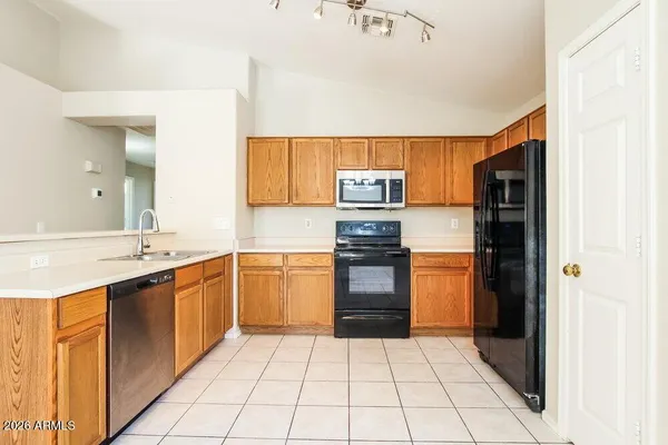 a kitchen with stainless steel appliances granite countertop a refrigerator and a stove top oven