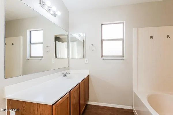a bathroom with a sink a mirror and a bathtub