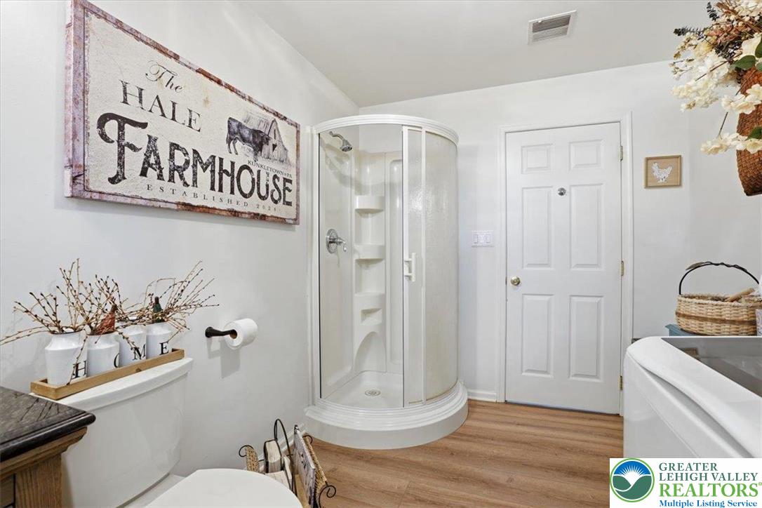 4880 Little Gap Road Kunkletown, PA 18058 - Photo 41 of 100 This clean and inviting bathroom features a convenient corner shower and wood-look flooring.