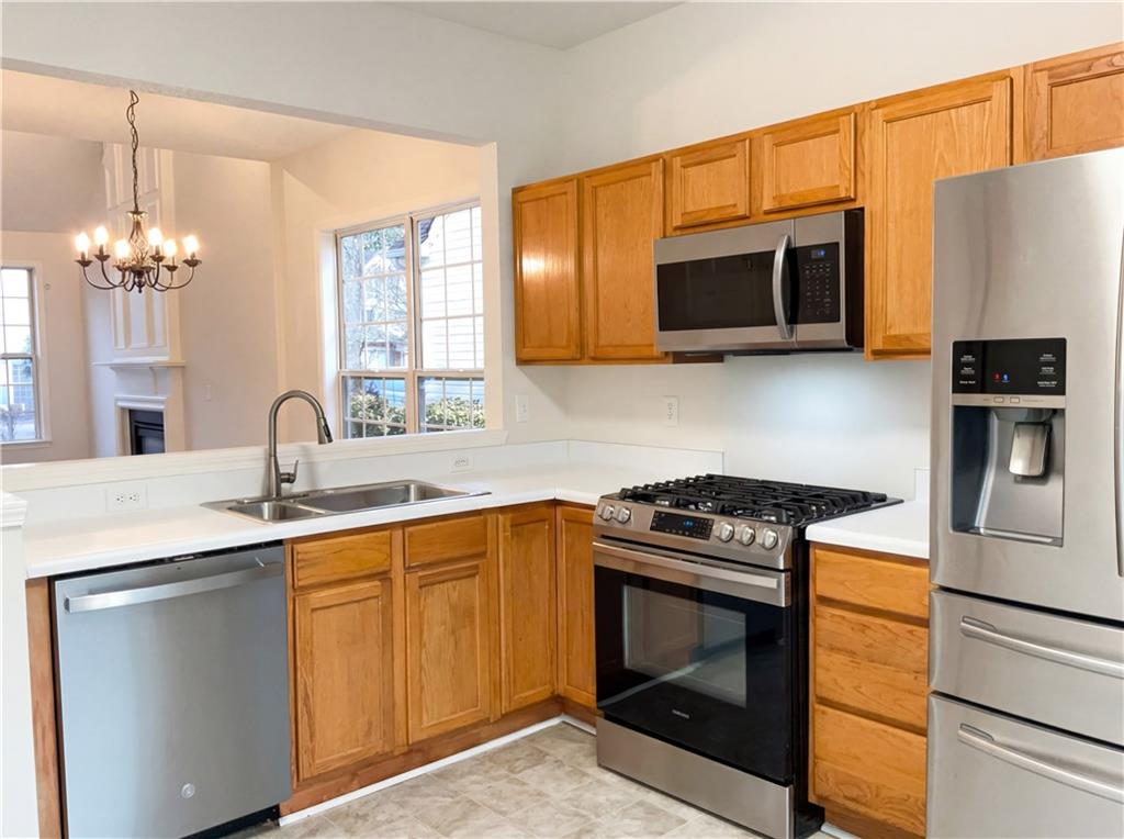 1639 Woodsford Road Kennesaw, GA 30152 - Photo 11 of 31 a kitchen with stainless steel appliances a stove microwave and sink