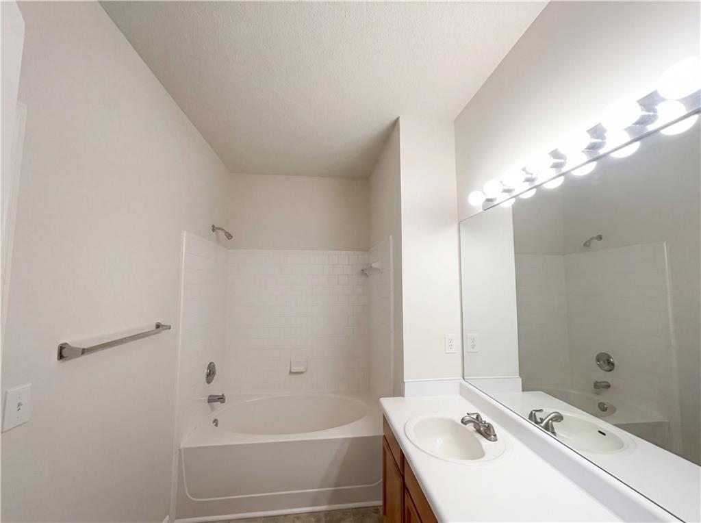 1639 Woodsford Road Kennesaw, GA 30152 - Photo 15 of 31 a bathroom with a sink a toilet and shower