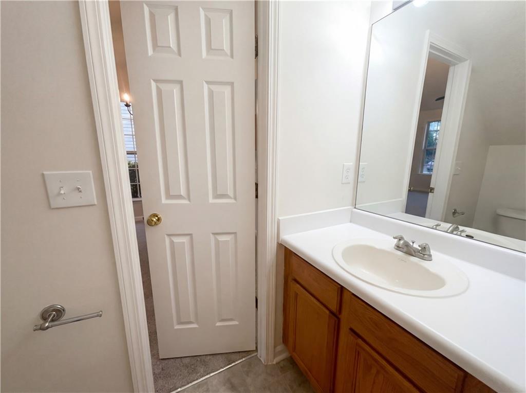 1639 Woodsford Road Kennesaw, GA 30152 - Photo 17 of 31 a bathroom with a sink vanity and a mirror