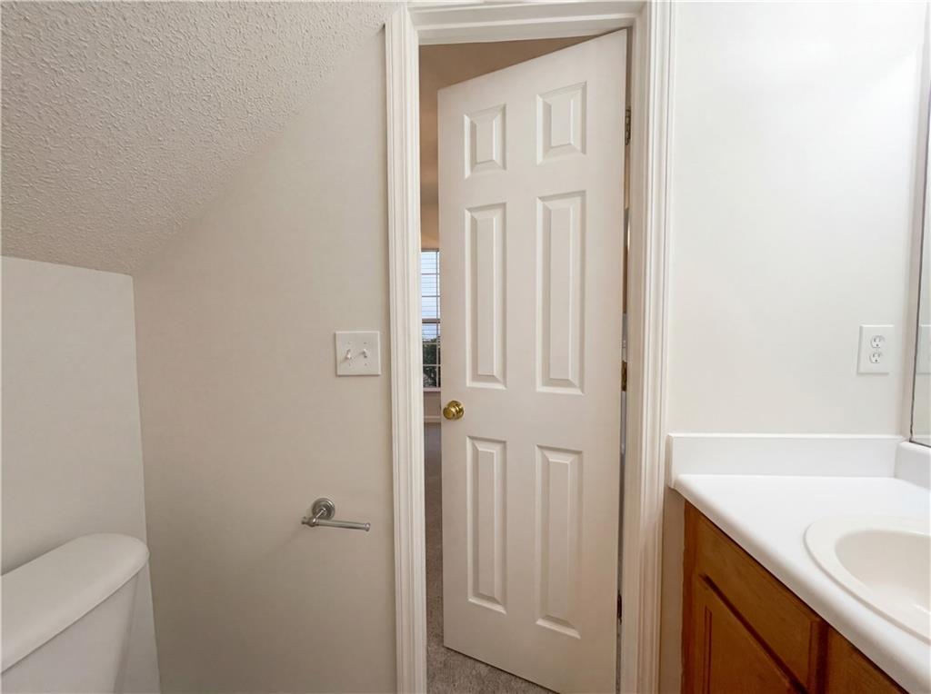 1639 Woodsford Road Kennesaw, GA 30152 - Photo 18 of 31 a bathroom with a granite countertop sink and a toilet