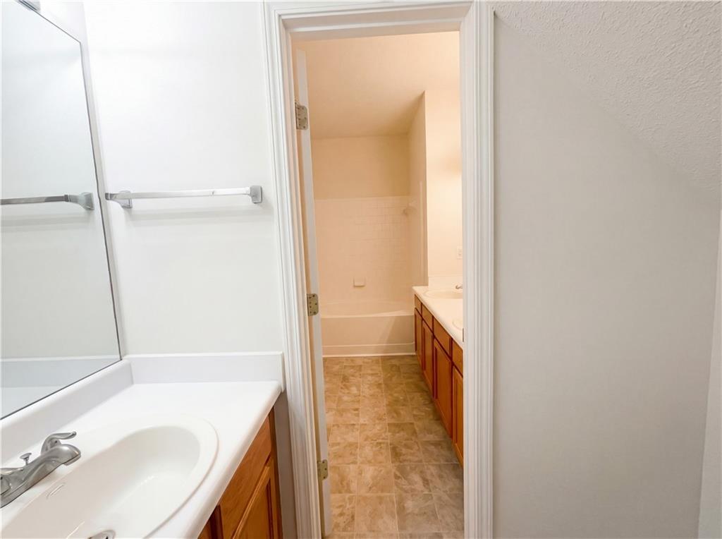1639 Woodsford Road Kennesaw, GA 30152 - Photo 19 of 31 a bathroom with a granite countertop sink toilet and shower