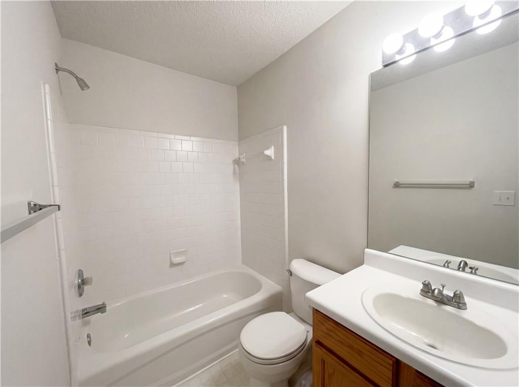 1639 Woodsford Road Kennesaw, GA 30152 - Photo 25 of 31 a bathroom with a bathtub shower sink vanity mirror and toilet