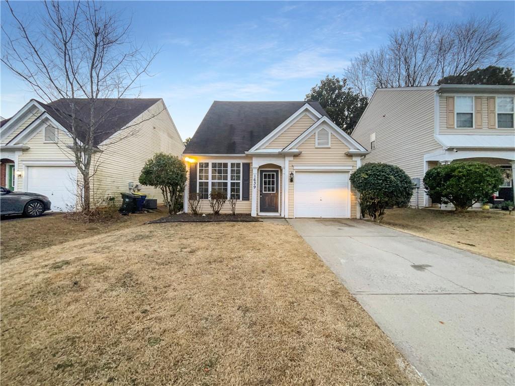 1639 Woodsford Road Kennesaw, GA 30152 - Photo 29 of 31 a front view of a house with a yard and garage