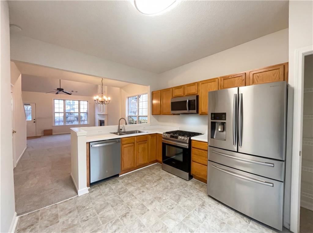 1639 Woodsford Road Kennesaw, GA 30152 - Photo 3 of 31 a kitchen with granite countertop stainless steel appliances and cabinets