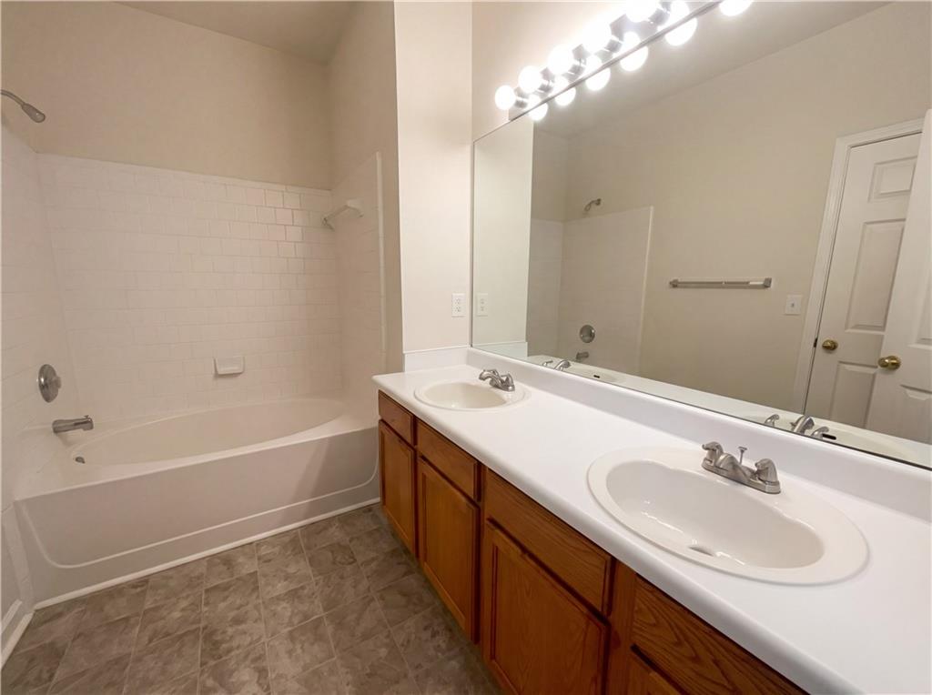 1639 Woodsford Road Kennesaw, GA 30152 - Photo 5 of 31 a bathroom with a sink double vanity granite tub and a mirror