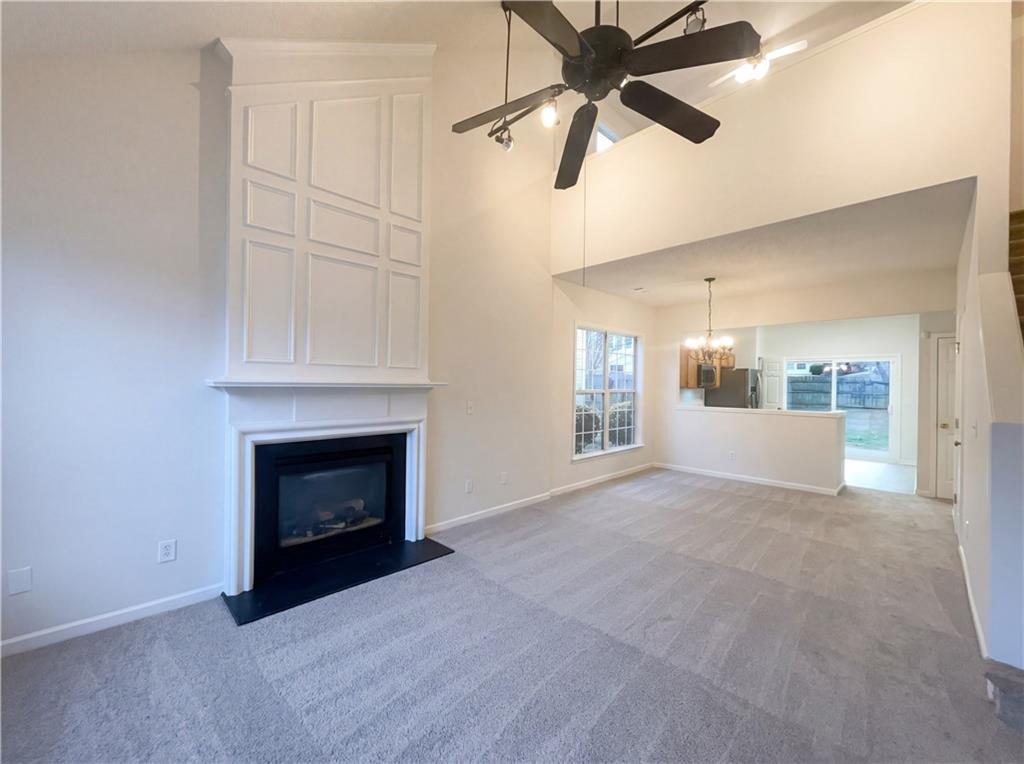 1639 Woodsford Road Kennesaw, GA 30152 - Photo 6 of 31 an empty room with windows and fireplace