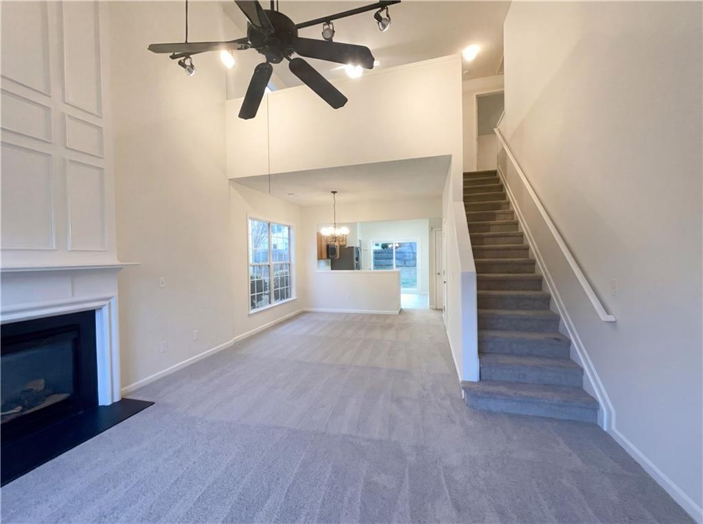 1639 Woodsford Road Kennesaw, GA 30152 - Photo 8 of 31 wooden floor in an empty room with a fireplace