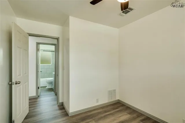 a view of a room with wooden floor